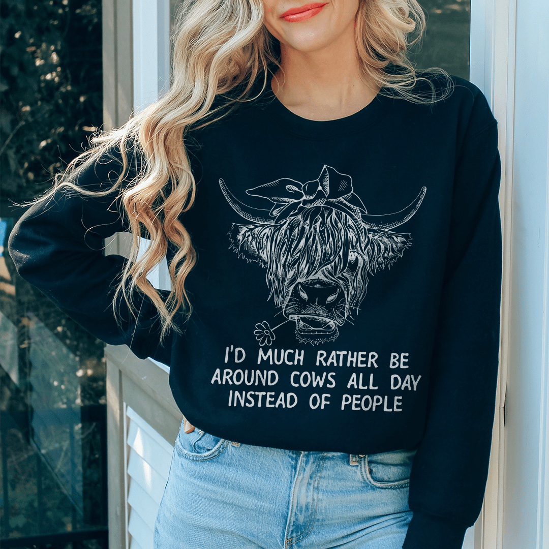 Cozy sweatshirt featuring the phrase 'I'd Much Rather Be Around Cows All Day Instead Of People', made from cotton/poly fleece blend.