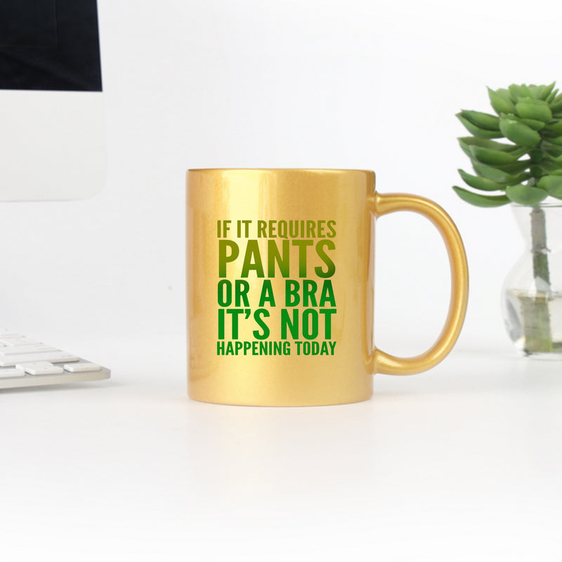 Ceramic mug with gold and silver design featuring the phrase 'If It Requires Pants Or A Bra Its Not Happening Today', perfect for casual lounging.