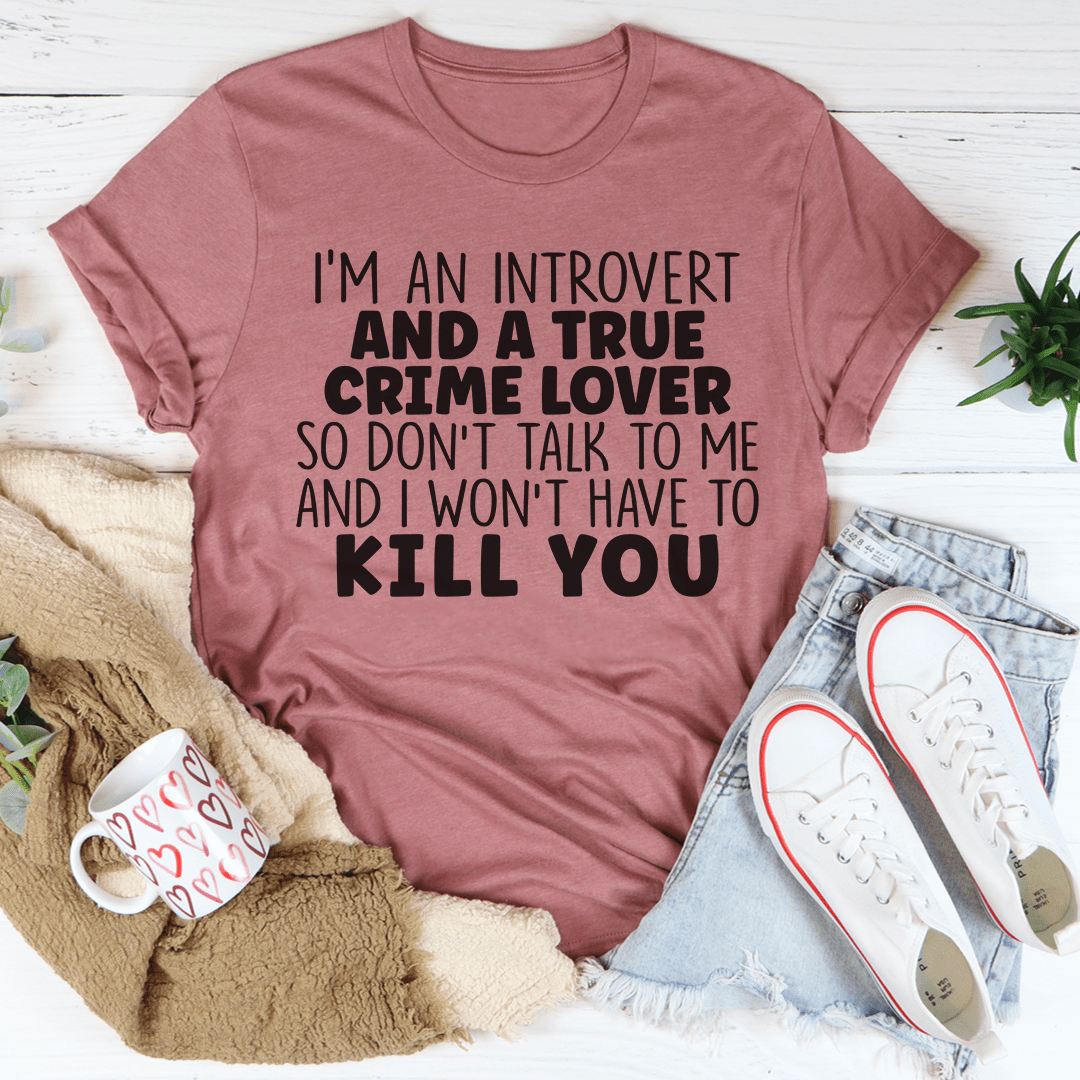 A stylish black t-shirt with the phrase 'I'm An Introvert And A True Crime Lover' printed in bold letters, showcasing a comfortable fit.