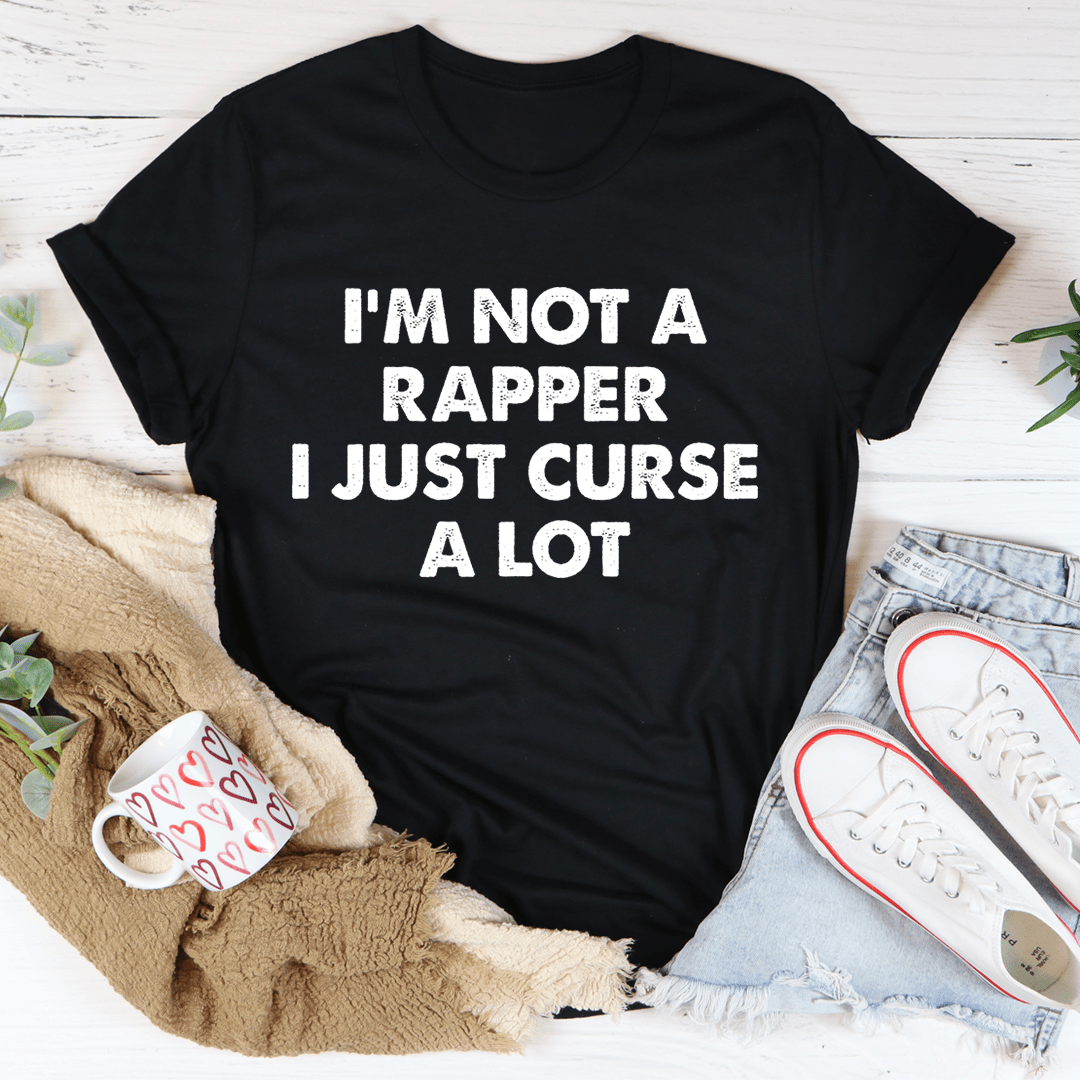 Black t-shirt with the phrase 'I'm Not A Rapper I Just Curse A Lot' printed in bold white letters, showcasing a casual and humorous style.