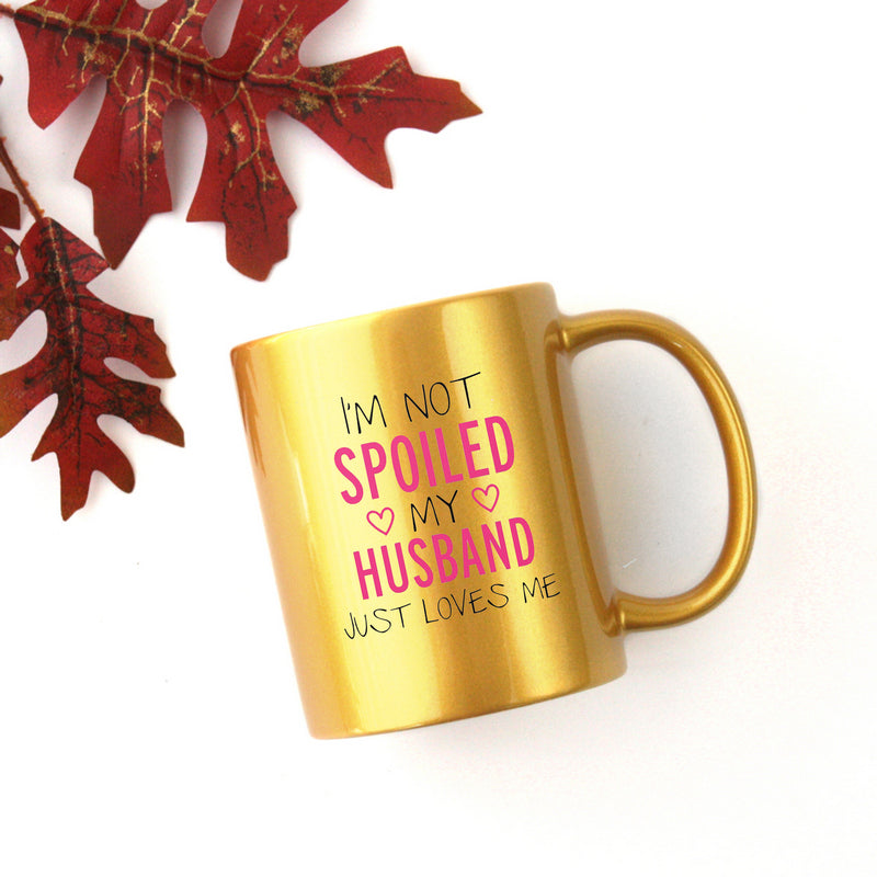 Ceramic gold and silver mug with the phrase 'I'm Not Spoiled My Husband Just Loves Me' elegantly displayed.