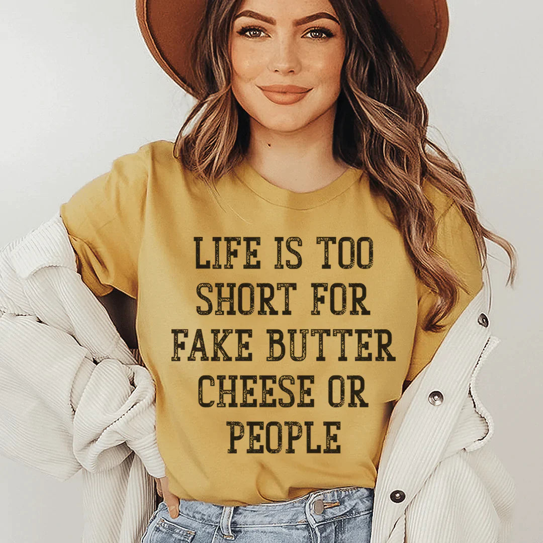 A comfortable and stylish t-shirt featuring the phrase 'Life Is Too Short For Fake Butter Cheese Or People', made from soft cotton.