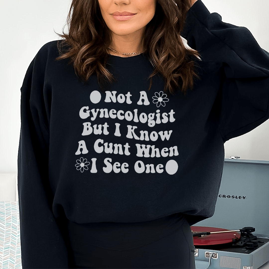 A cozy hoodie featuring the phrase 'Not A Gynecologist But I Know A Cunt When I See One', designed for comfort and style.