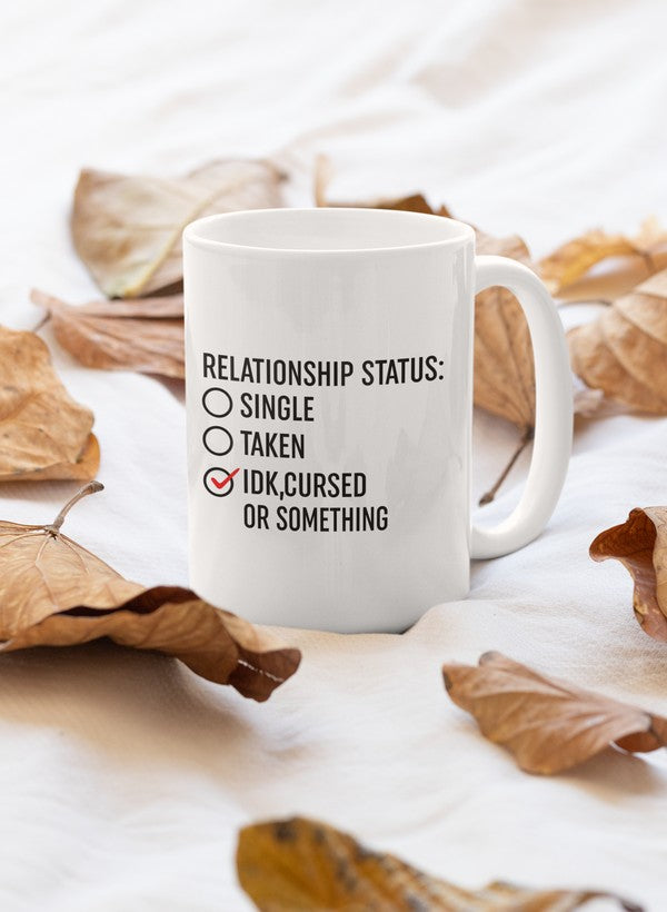 A stylish 11oz ceramic mug with a humorous 'Relationship Status Cursed Or Something' design, featuring a glossy finish and sturdy handle.