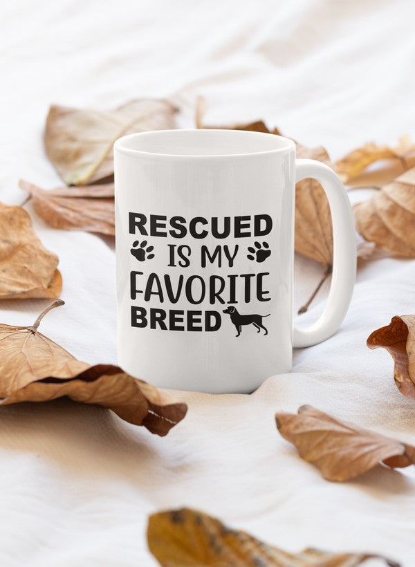 A glossy white ceramic mug with the text 'Rescued Is My Favorite Breed' printed in a stylish font, showcasing a heartwarming message for animal lovers.