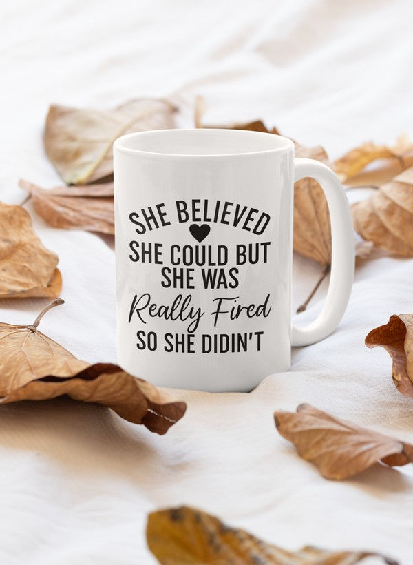 A stylish 11oz ceramic mug with the inspirational quote 'She Believed She Could' printed on it, featuring a glossy finish and sturdy handle.