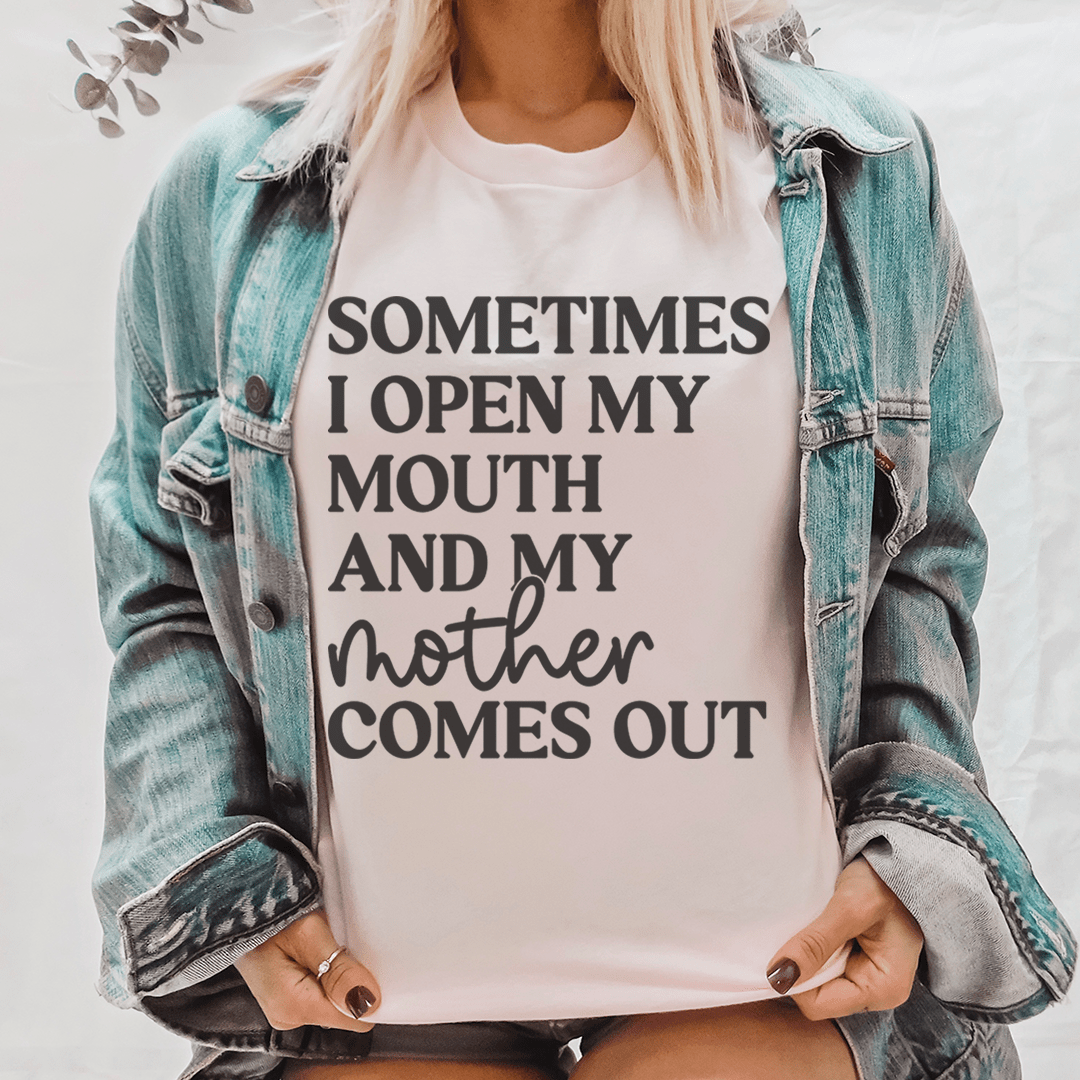 A comfortable and stylish t-shirt featuring the phrase 'Sometimes I Open My Mouth And My Mother Comes Out' printed on it, made from soft cotton.