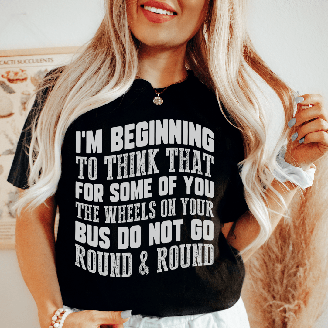 A comfortable and stylish t-shirt featuring the phrase 'The Wheels On Your Bus Do Not Go Round & Round', made from soft ring-spun cotton.