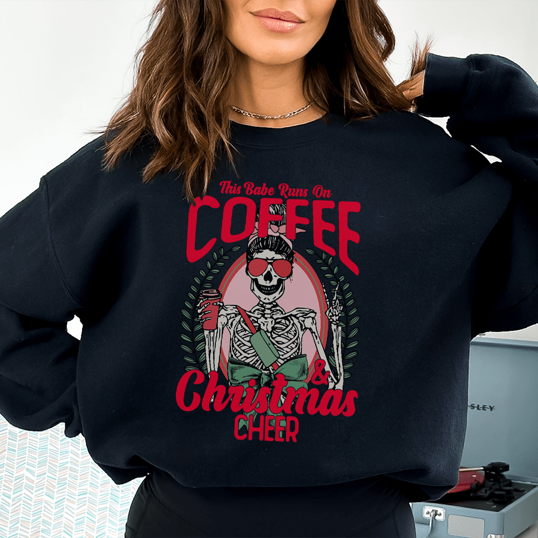 Cozy hoodie with 'This Babe Runs On Coffee & Christmas Cheer' design, featuring a warm fleece lining and adjustable cuffs.