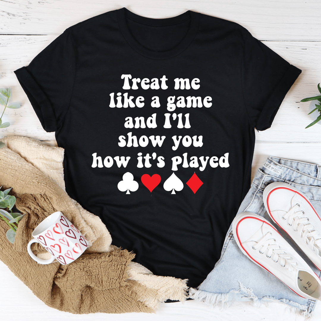 A stylish black t-shirt featuring the phrase 'Treat Me Like A Game And I'll Show You How's It's Played' printed in bold letters.