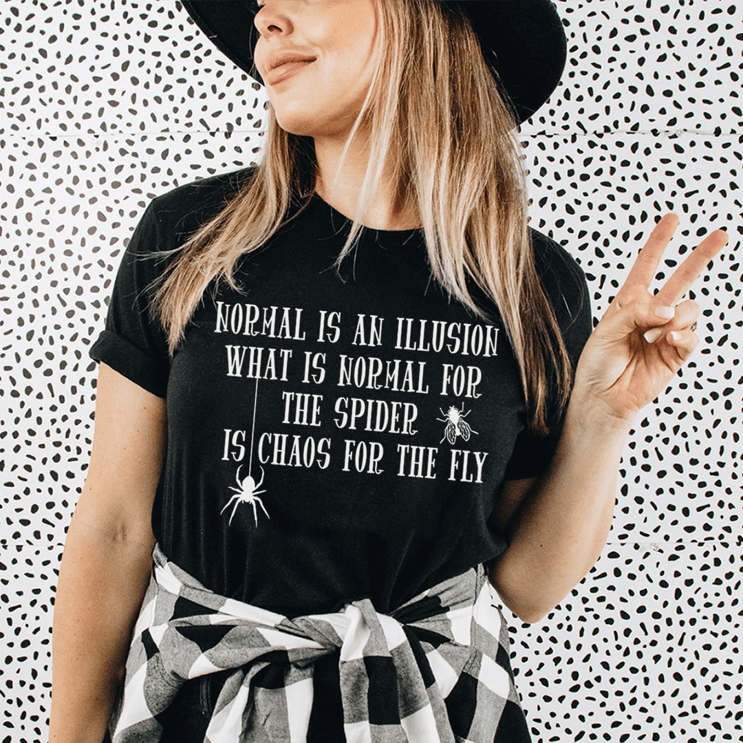 A stylish t-shirt featuring the phrase 'What Is Normal For The Spider Is Chaos For The Fly', made from soft ring-spun cotton with double stitching.