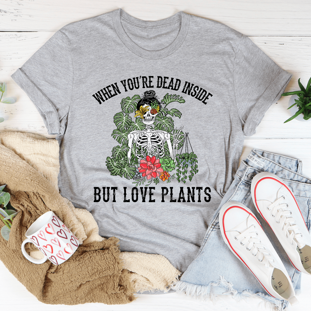 A stylish t-shirt featuring the phrase 'When You Are Dead Inside But Love Plants', made from soft cotton with a comfortable fit.