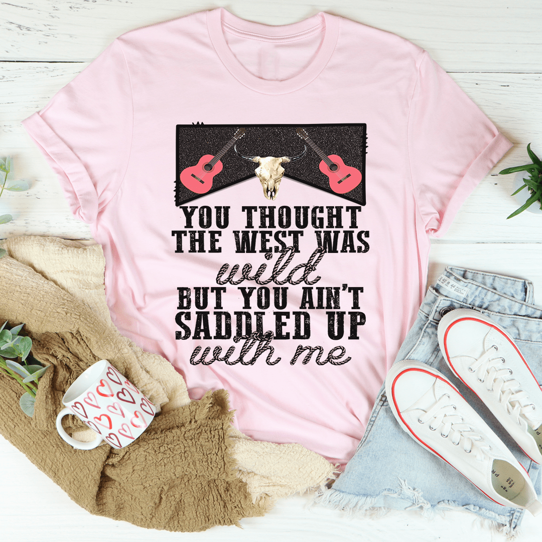 You Thought The West Was Wild T-Shirt displayed on a hanger, showcasing its soft fabric and unique design.