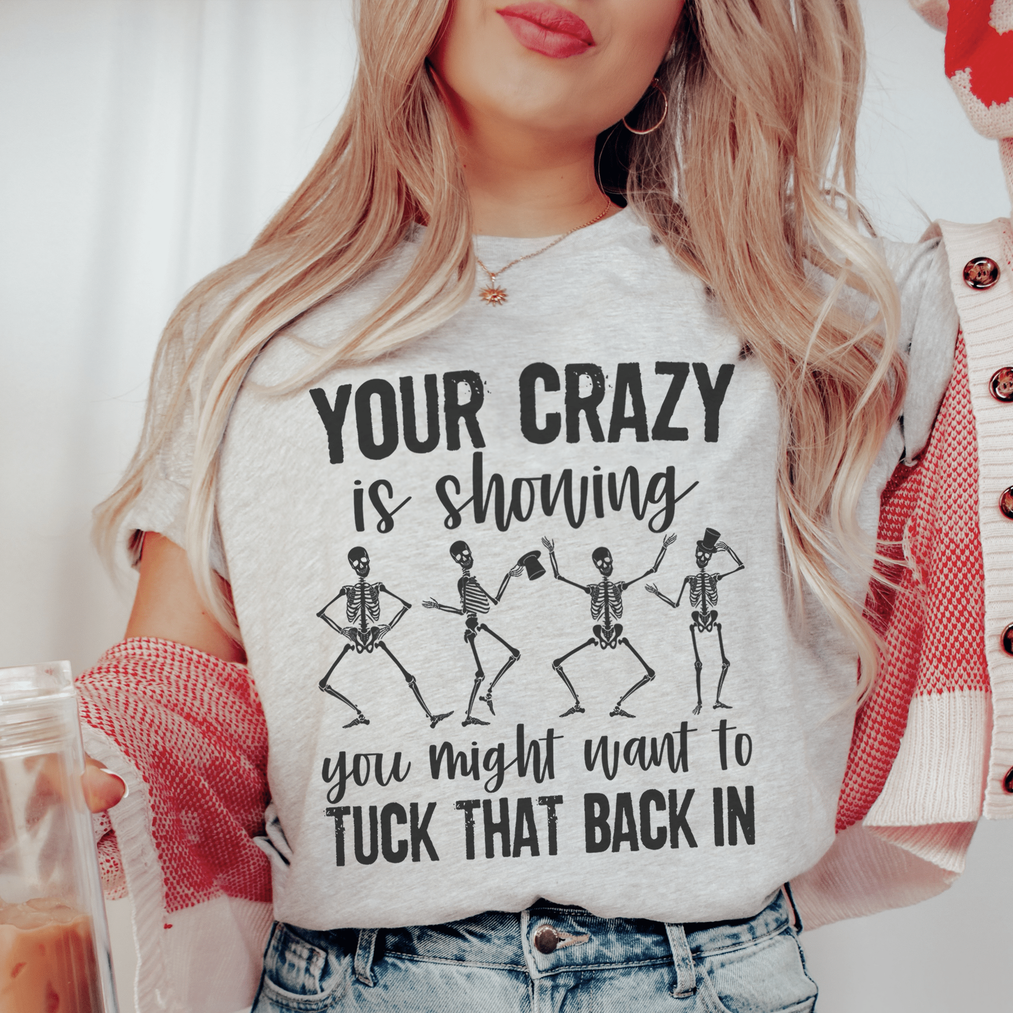 A stylish t-shirt featuring the phrase 'Your Crazy Is Showing You Might Want To Tuck That Back In', made from soft ring-spun cotton with a durable design.