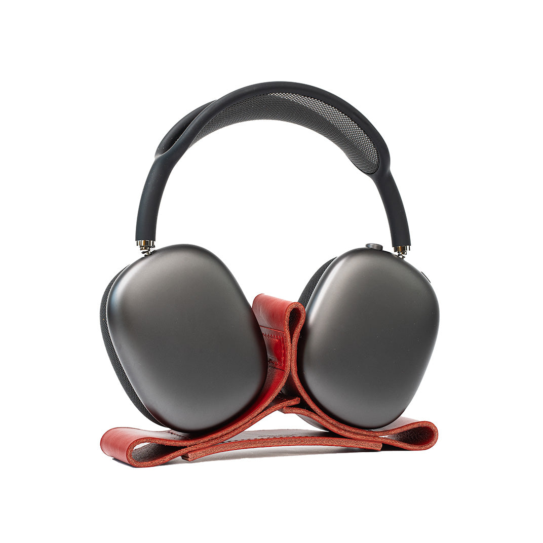 Red leather stand designed specifically for AirPods Max, featuring a minimalist design and non-slip base for secure headphone storage.