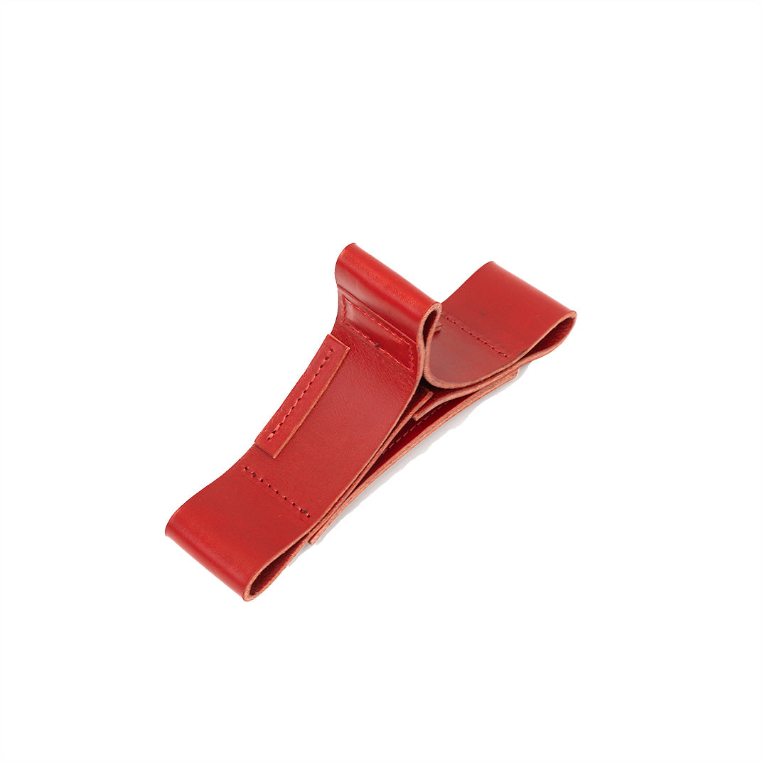 Red leather stand designed specifically for AirPods Max, featuring a minimalist design and non-slip base for secure headphone storage.