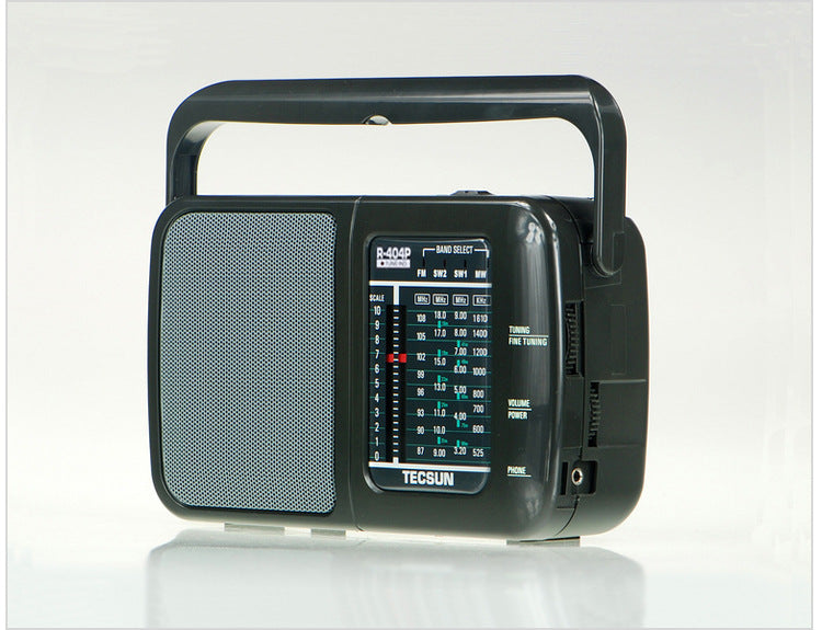 Portable AC and DC radio with built-in speaker, compact design, and power cord.