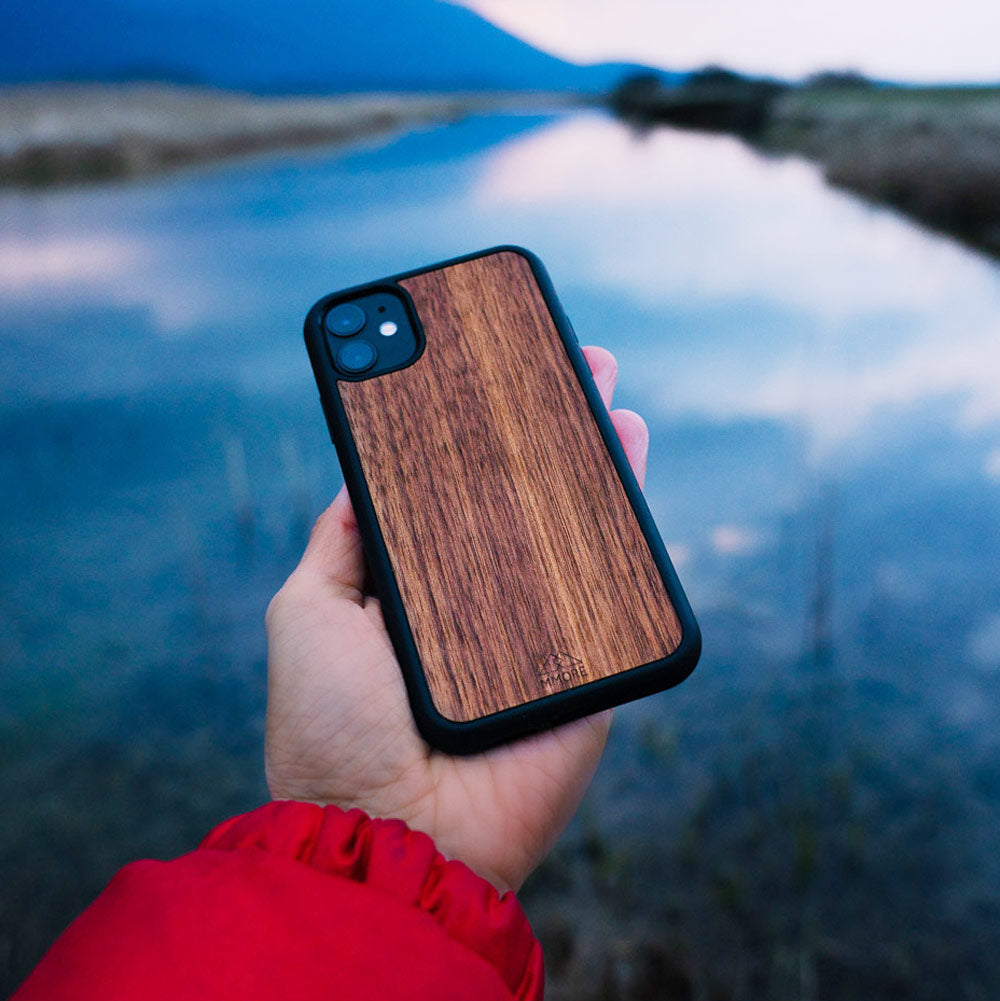 Handcrafted American Walnut phone case showcasing unique wood grain and elegant design, perfect for modern smartphones.