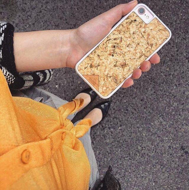 Organic Jasmine Phone Case held by a woman, showcasing its unique design and natural materials.
