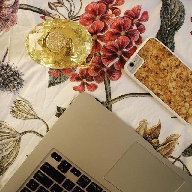 Organic Jasmine Phone Case held by a woman, showcasing its unique design and natural materials.