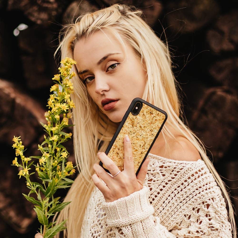 Organic Jasmine Phone Case held by a woman, showcasing its unique design and natural materials.