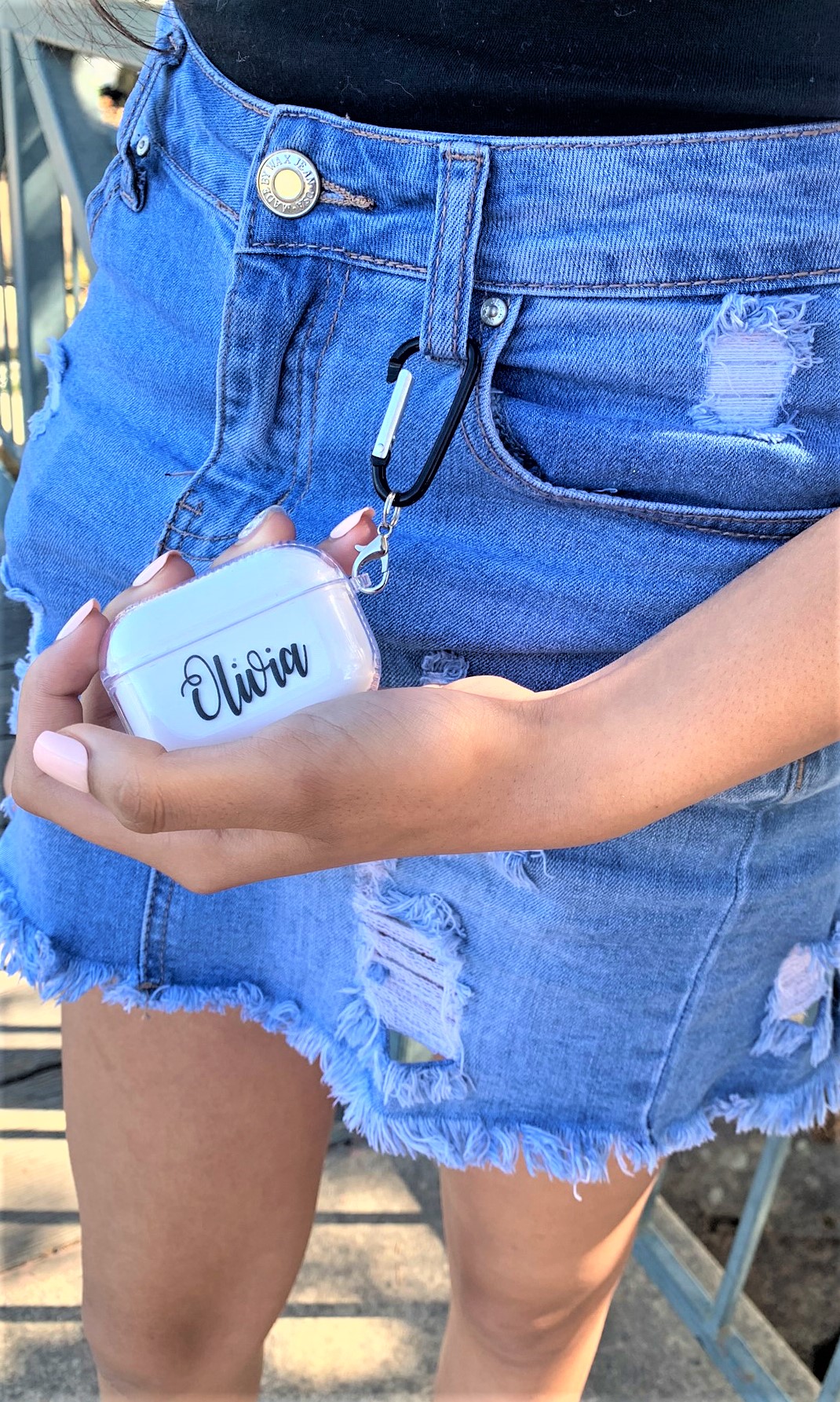 A personalized transparent case for Apple AirPods Pro, showcasing a sleek design with a metal strap attached.
