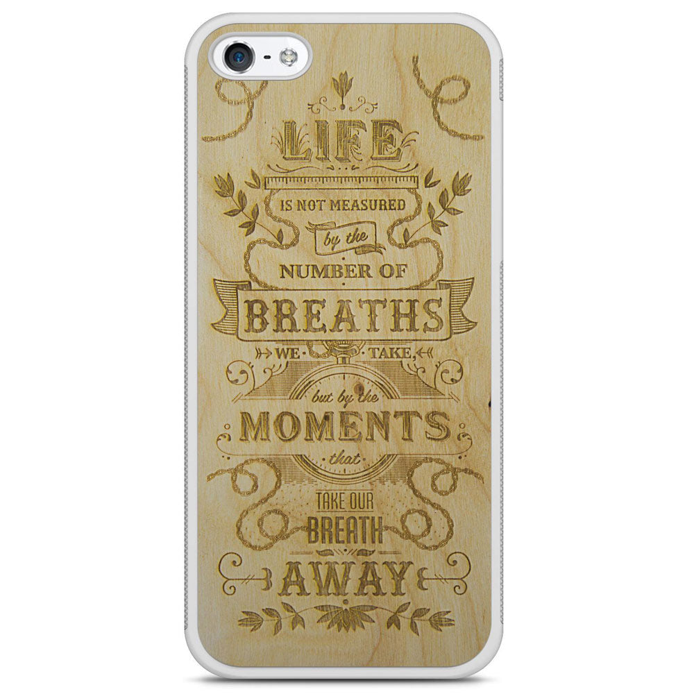 The Meaning wooden phone case displayed outdoors, showcasing its unique grain and design, held by a woman in a natural setting.