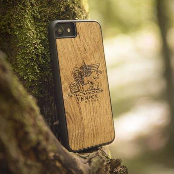 Handcrafted Venice phone case featuring the Lion of St. Marco, made from ancient oak wood, showcasing its unique grain and engraving.