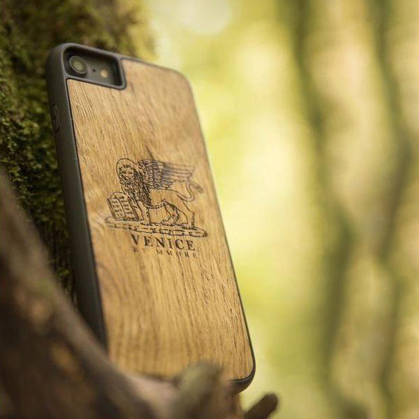 Handcrafted Venice phone case featuring the Lion of St. Marco, made from ancient oak wood, showcasing its unique grain and engraving.