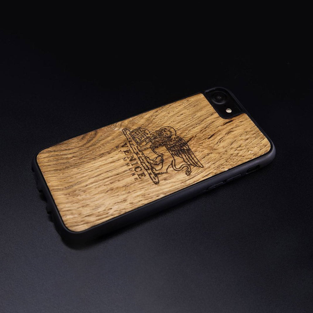 Handcrafted Venice phone case featuring the Lion of St. Marco, made from ancient oak wood, showcasing its unique grain and engraving.