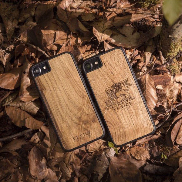 Handcrafted Venice phone case featuring the Lion of St. Marco, made from ancient oak wood, showcasing its unique grain and engraving.