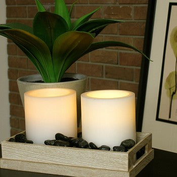 Flameless 4 x 5 Flat Top Wax Pillar Candle in a cozy setting, showcasing its realistic wax finish and warm glow.