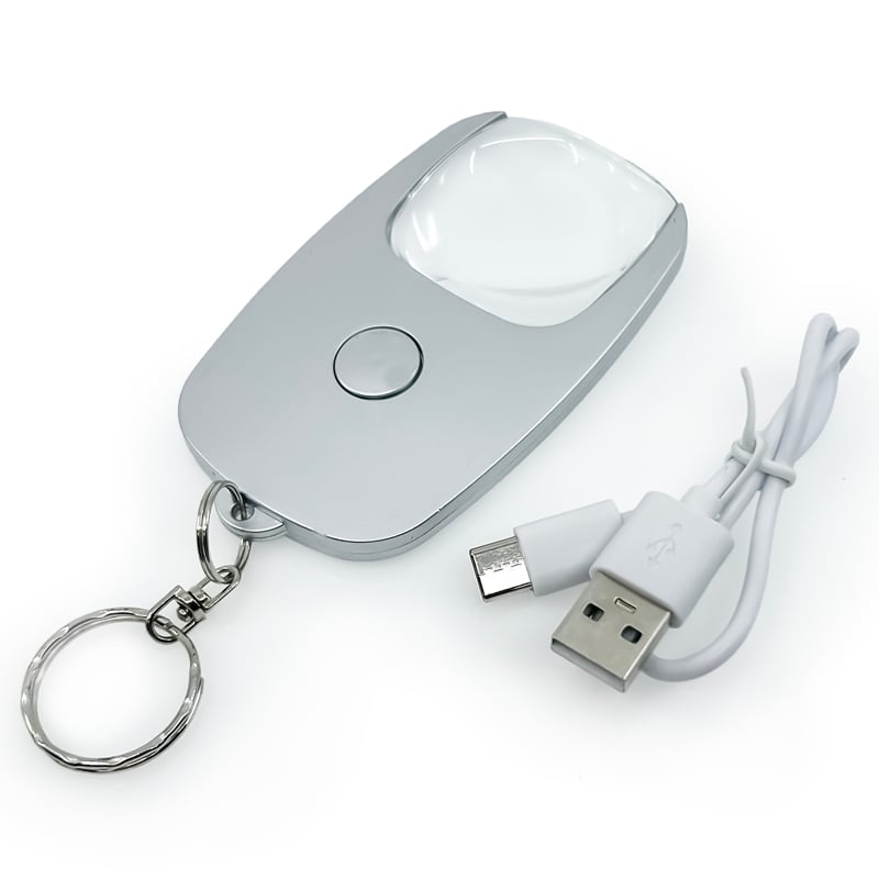 Pocket Zoom™ Recharge mini magnifier with LED light in gold, silver, and rose gold colors, showcasing its compact design and keyring attachment.