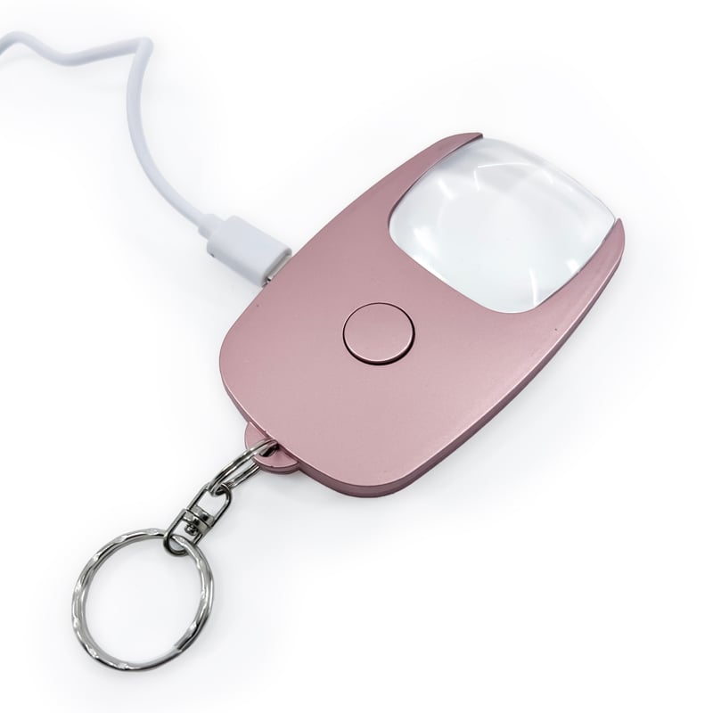 Pocket Zoom™ Recharge mini magnifier with LED light, compact design in gold, silver, and rose gold colors.