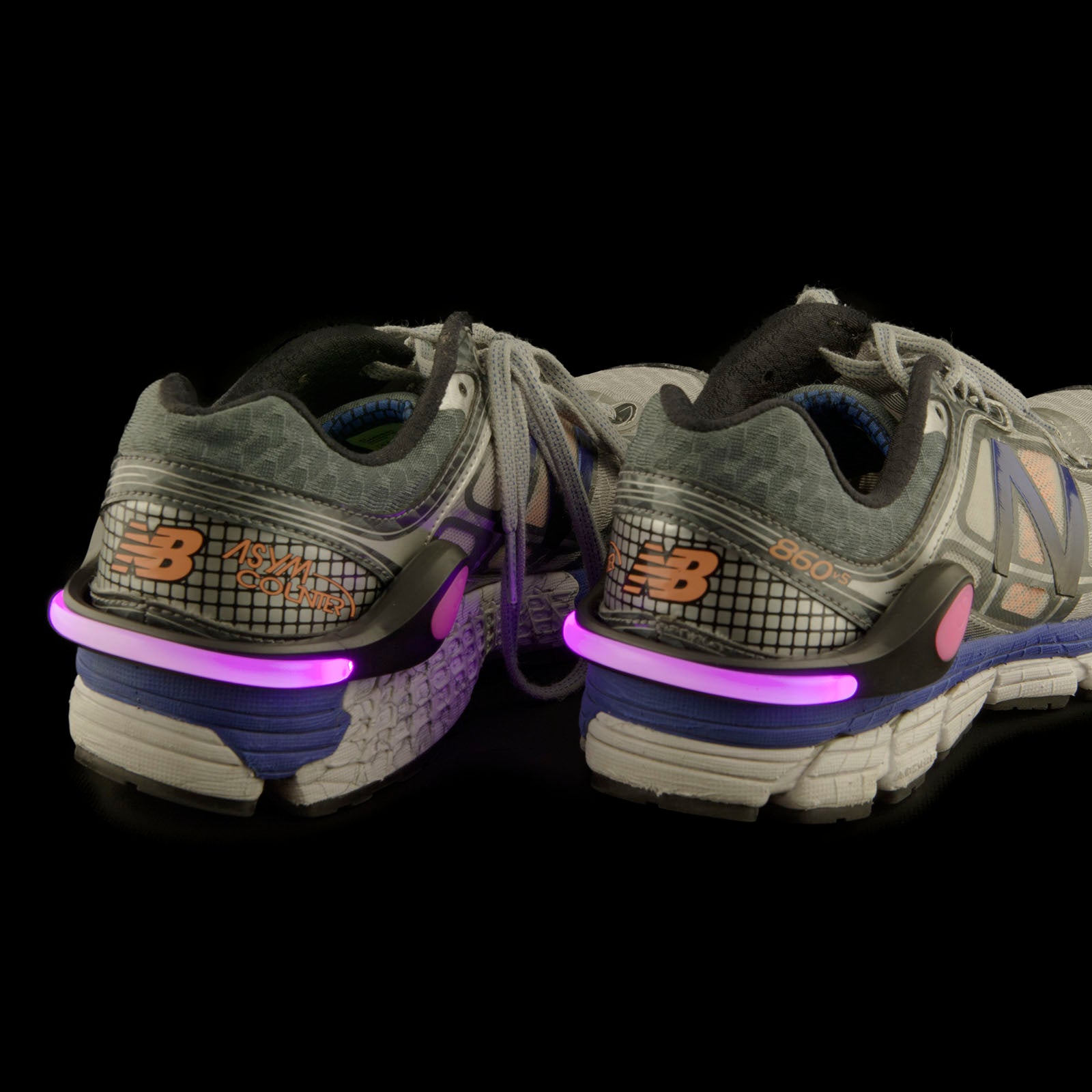 Safe Steps LED Clip On Shoe Lights in various colors attached to running shoes, providing visibility for nighttime activities.