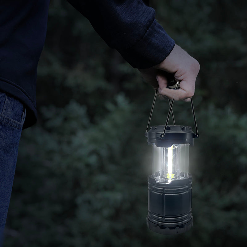 Slide-N-Glo™ COB LED Pop-Up Lantern in a compact design, showcasing its pull-up feature and bright LED light, ideal for outdoor adventures.