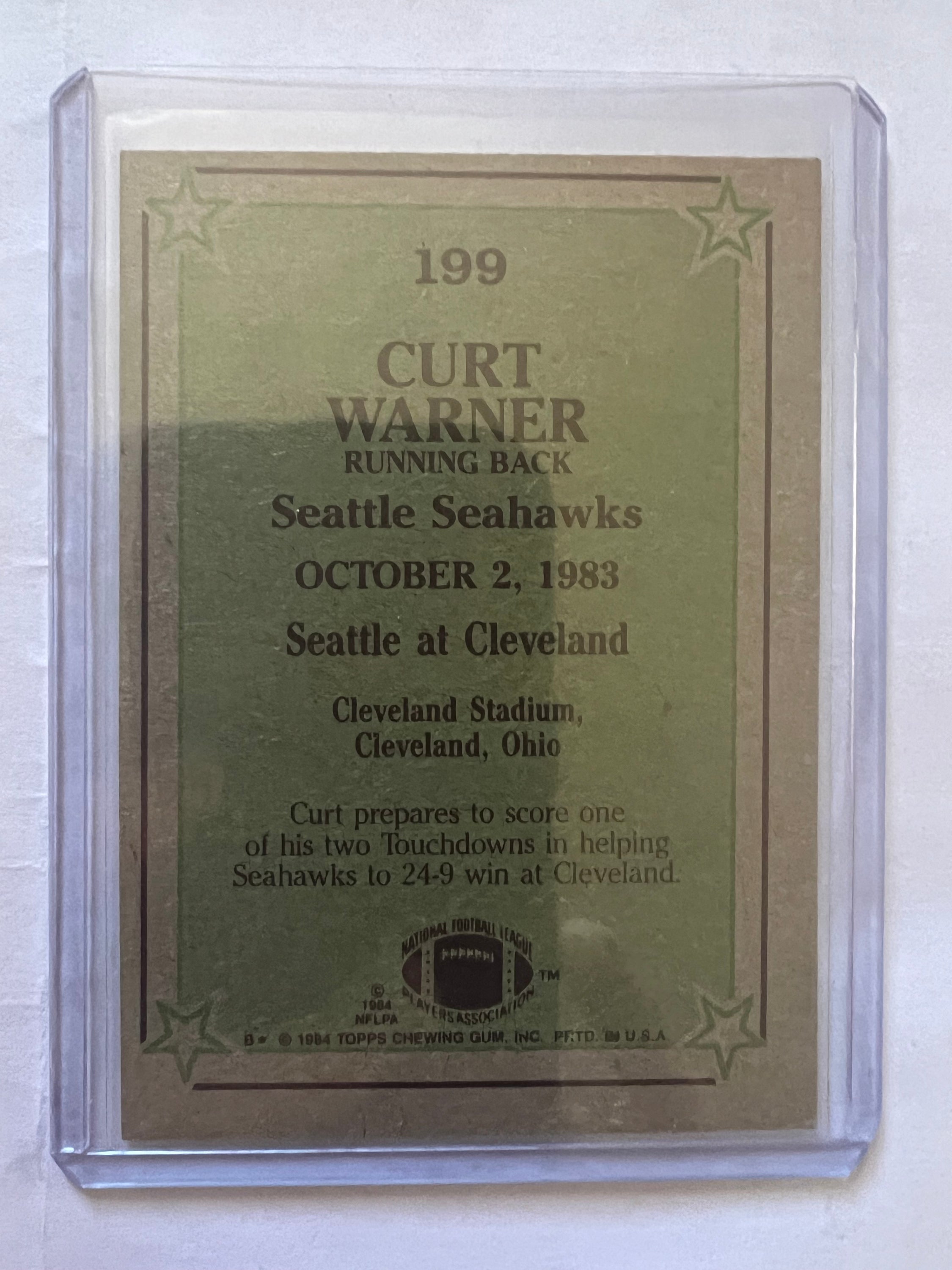 1984 Topps trading card featuring Curt Warner in Seattle Seahawks uniform, showcasing his dynamic pose on the field.