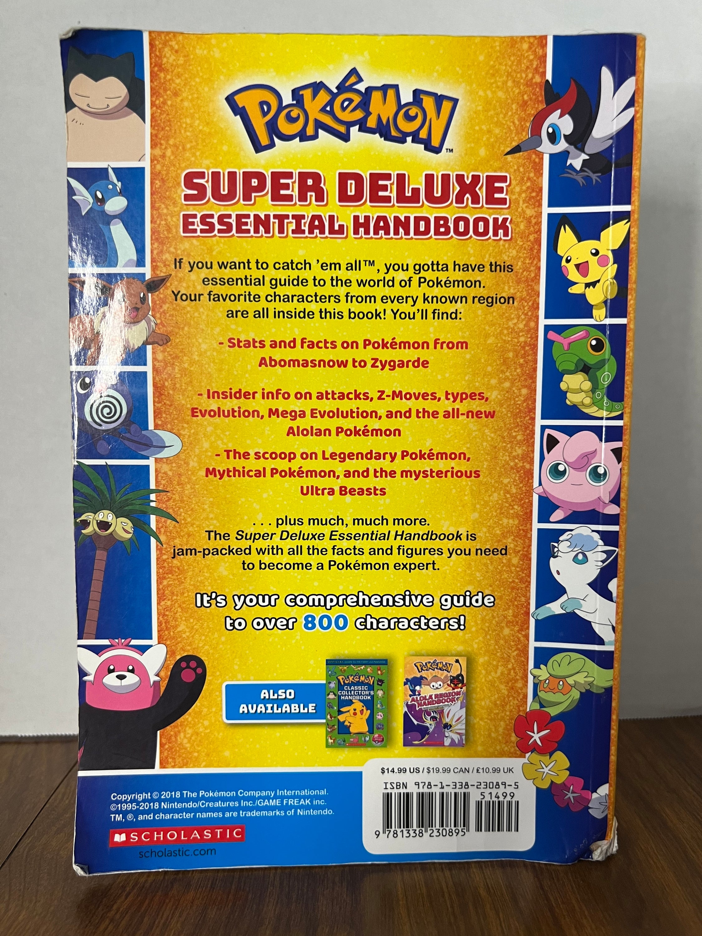 Cover of the Pokémon Super Deluxe Essential Handbook featuring colorful illustrations of various Pokémon characters.