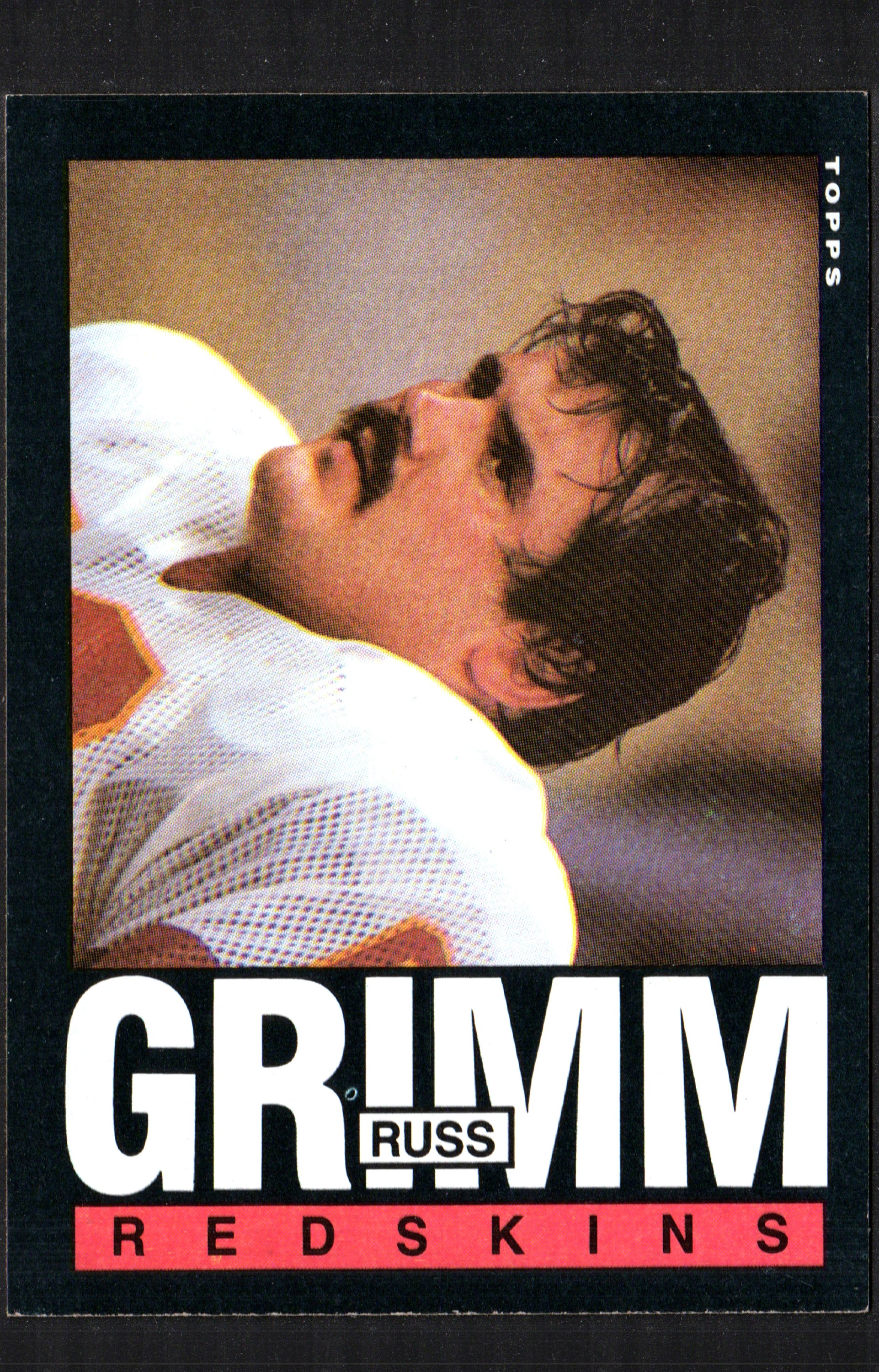 1985 Topps trading card featuring Russ Grimm of the Washington Redskins, showcasing his image and card details.