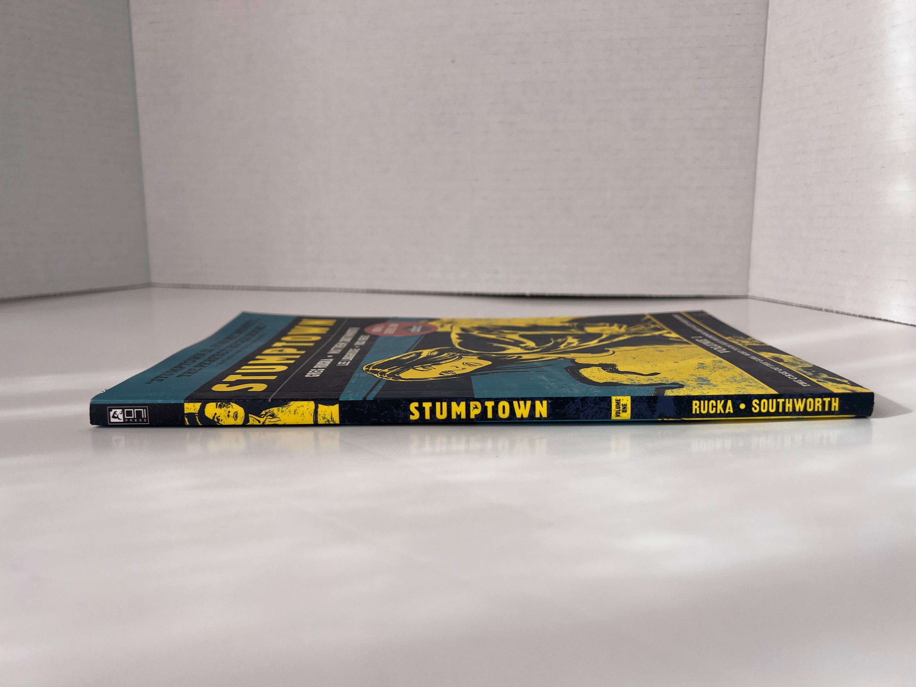 Stumptown Volume 1 paperback by Greg Rucka featuring Dex Parios on the cover, illustrated by Matthew Southworth.