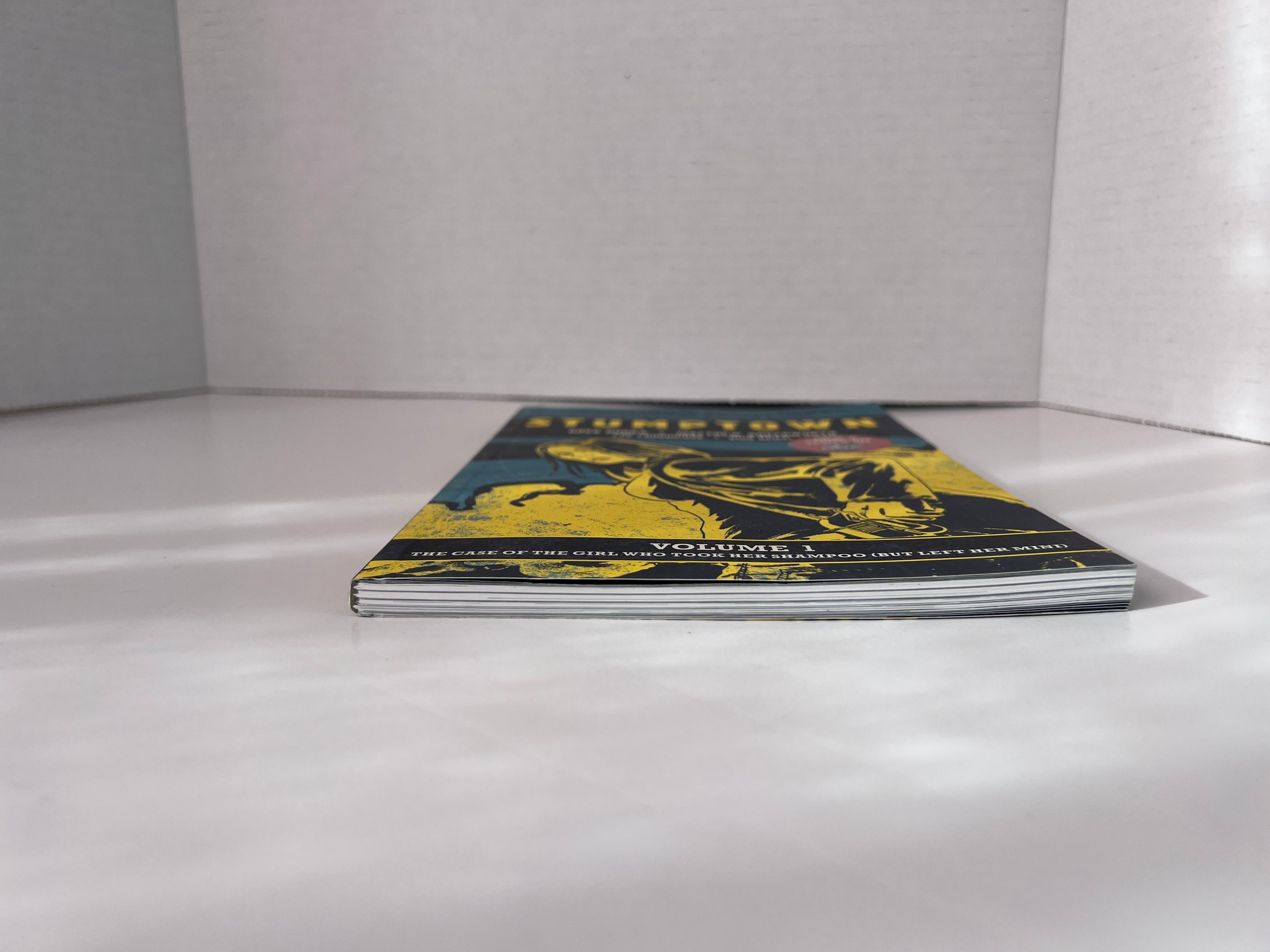 Stumptown Volume 1 paperback by Greg Rucka featuring Dex Parios on the cover, illustrated by Matthew Southworth.