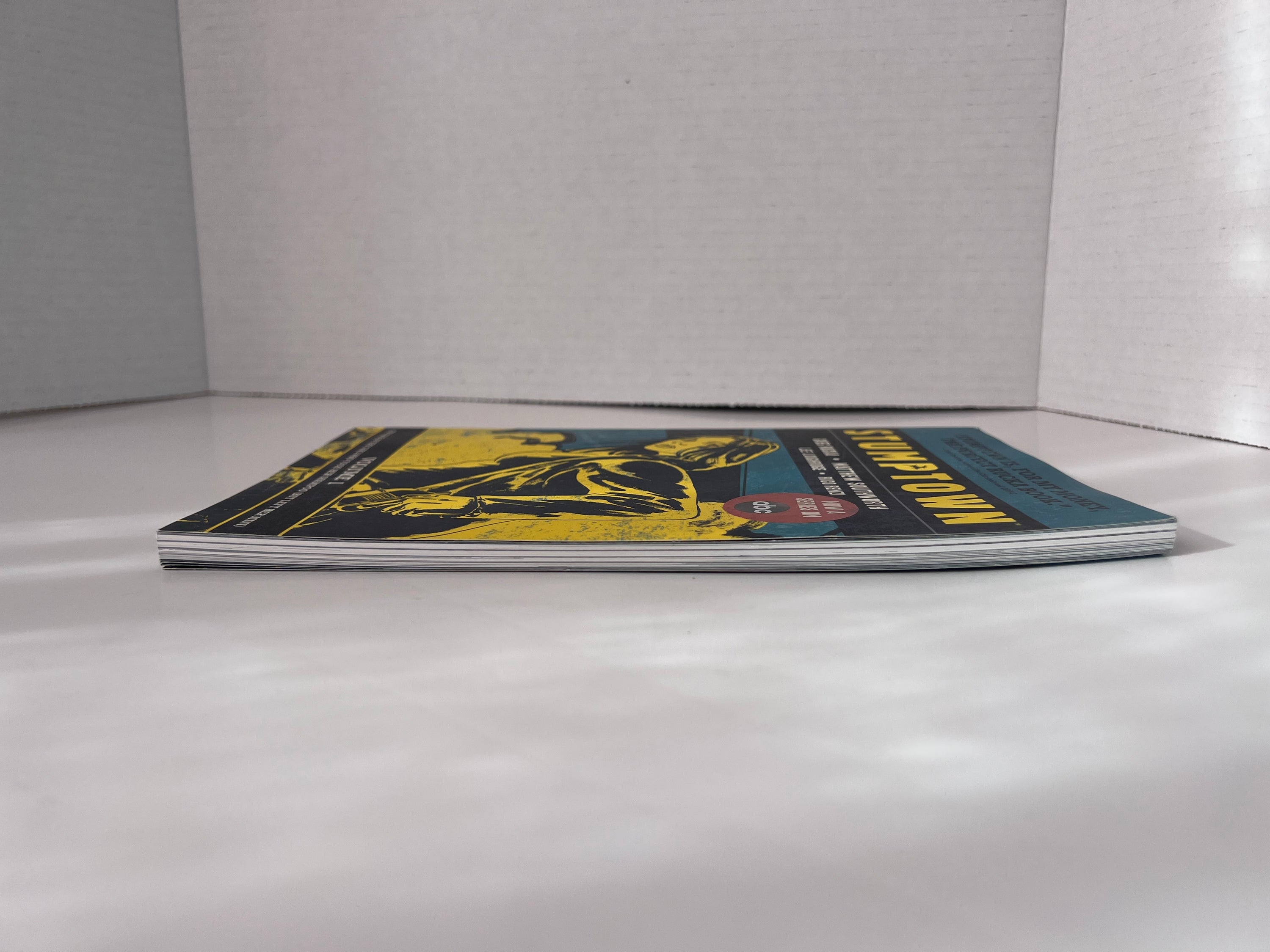 Stumptown Volume 1 paperback by Greg Rucka featuring Dex Parios on the cover, illustrated by Matthew Southworth.