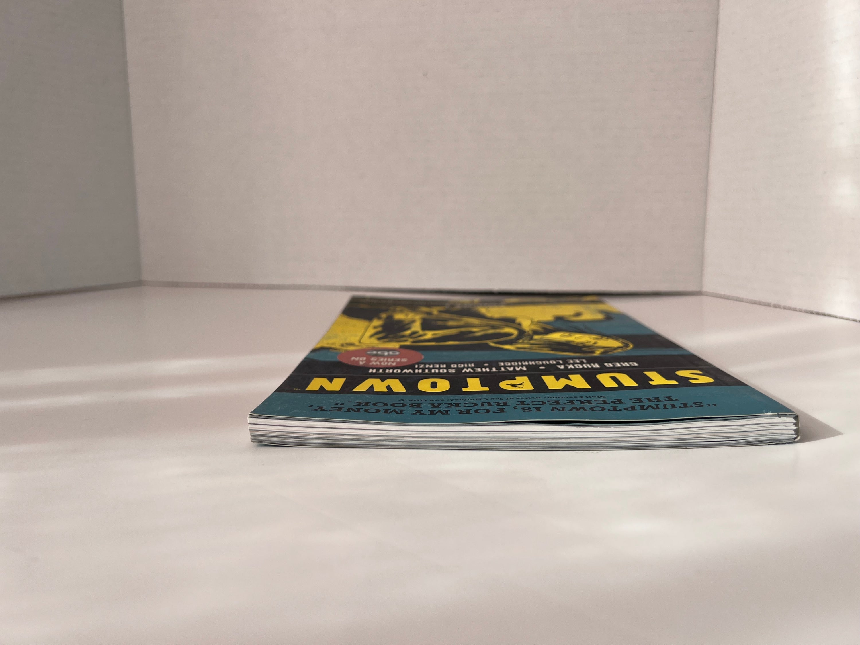 Stumptown Volume 1 paperback by Greg Rucka featuring Dex Parios on the cover, illustrated by Matthew Southworth.