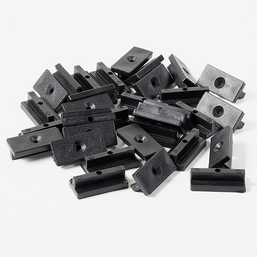 A set of 100 black composite decking hidden fixing fasteners, including T clips and screws, designed for seamless deck installation.