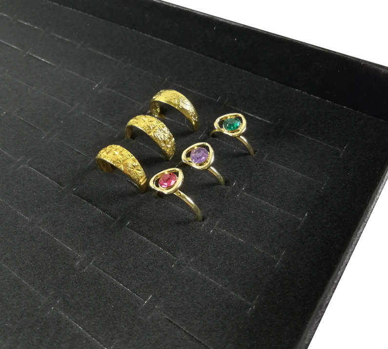 100 Slots Jewelry Ring Display Organizer Tray with transparent cover, showcasing rings and earrings in an elegant black design.