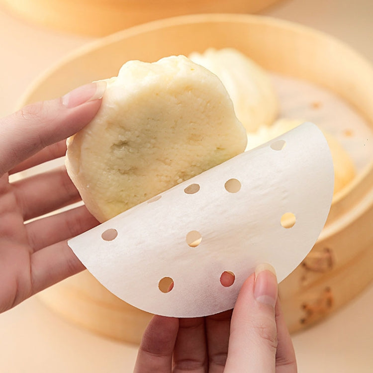 100pcs pack of non-stick disposable steamer paper, ideal for air fryers, steamers, and ovens, showcasing its perforated design for even cooking.
