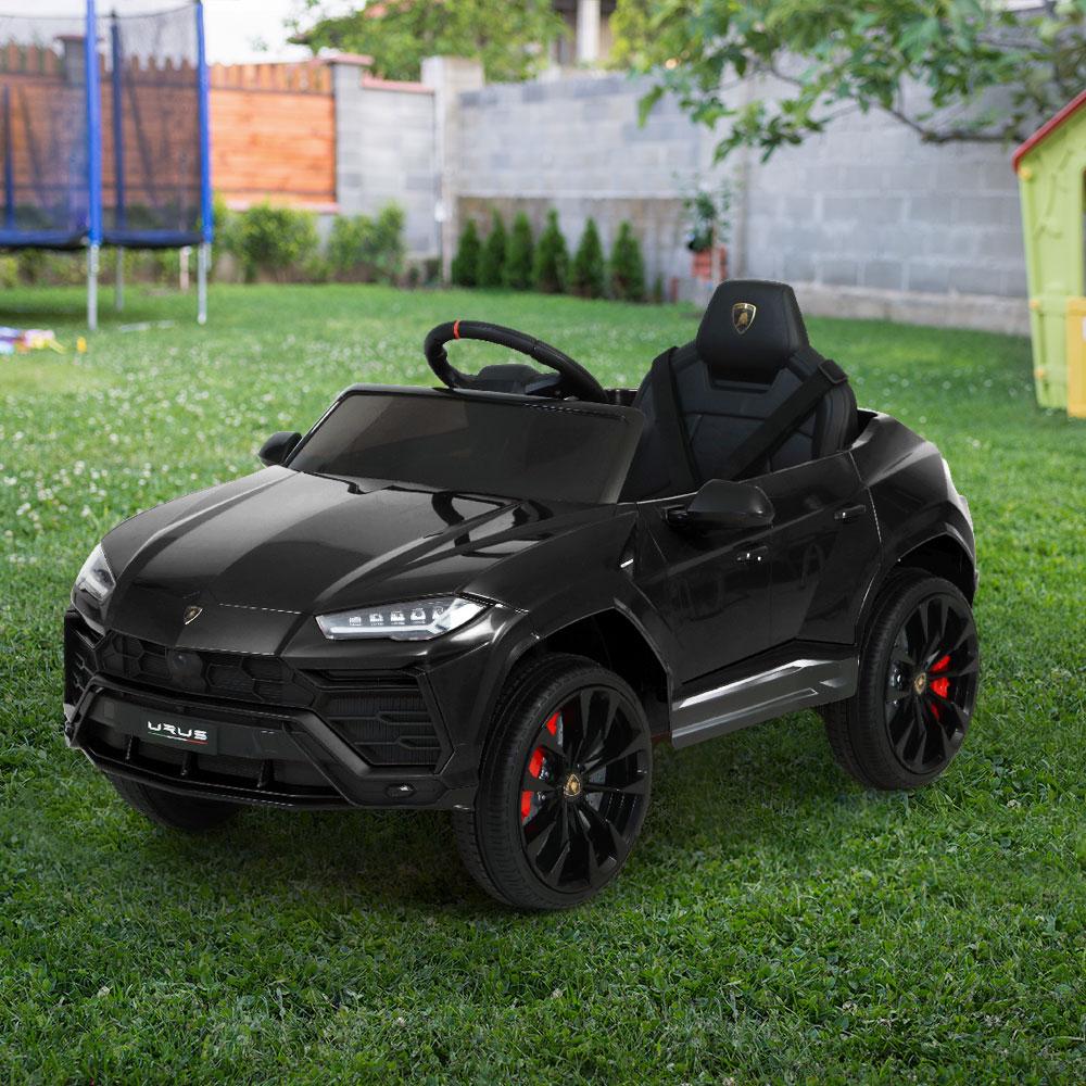 A black 12V Electric Kids Ride On Toy Car designed as a Lamborghini URUS, featuring working doors, a digital dashboard, and premium tires.