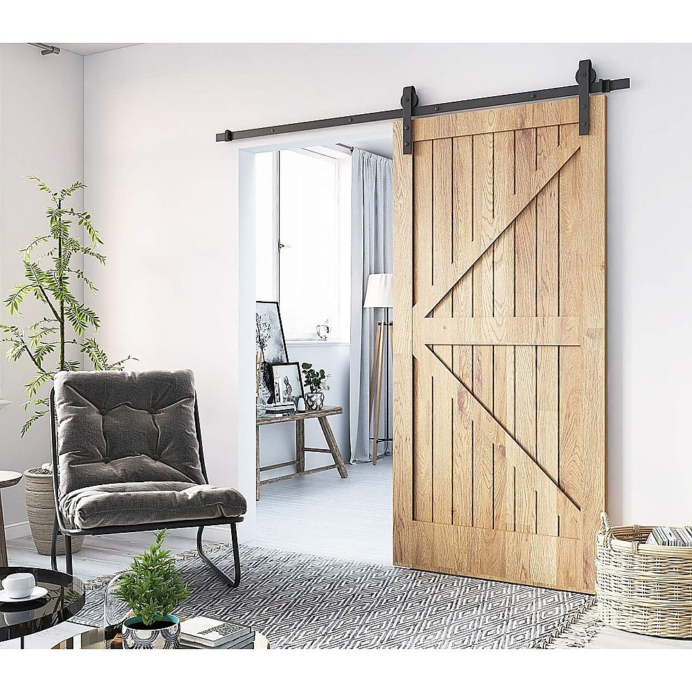 1.8m heavy-duty sliding barn door hardware kit featuring black industrial-grade metal components for rustic home decor.