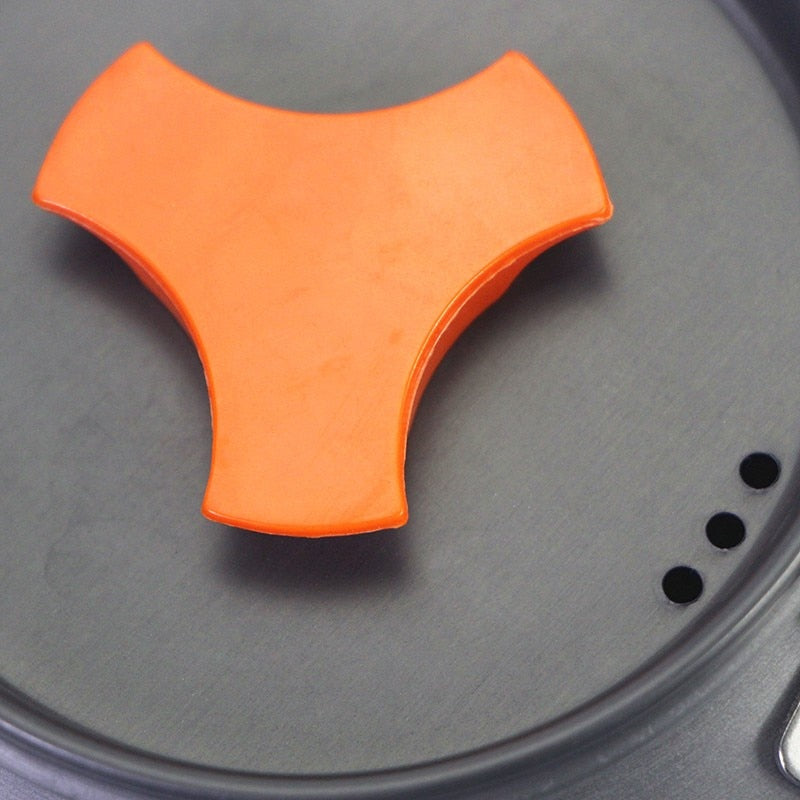 1.1L Camping Water Kettle made of aluminium alloy, perfect for outdoor coffee and cooking, shown in a natural setting.