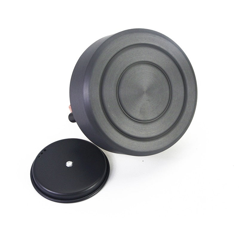 1.1L Camping Water Kettle made of aluminium alloy, perfect for outdoor coffee and cooking, shown in a natural setting.